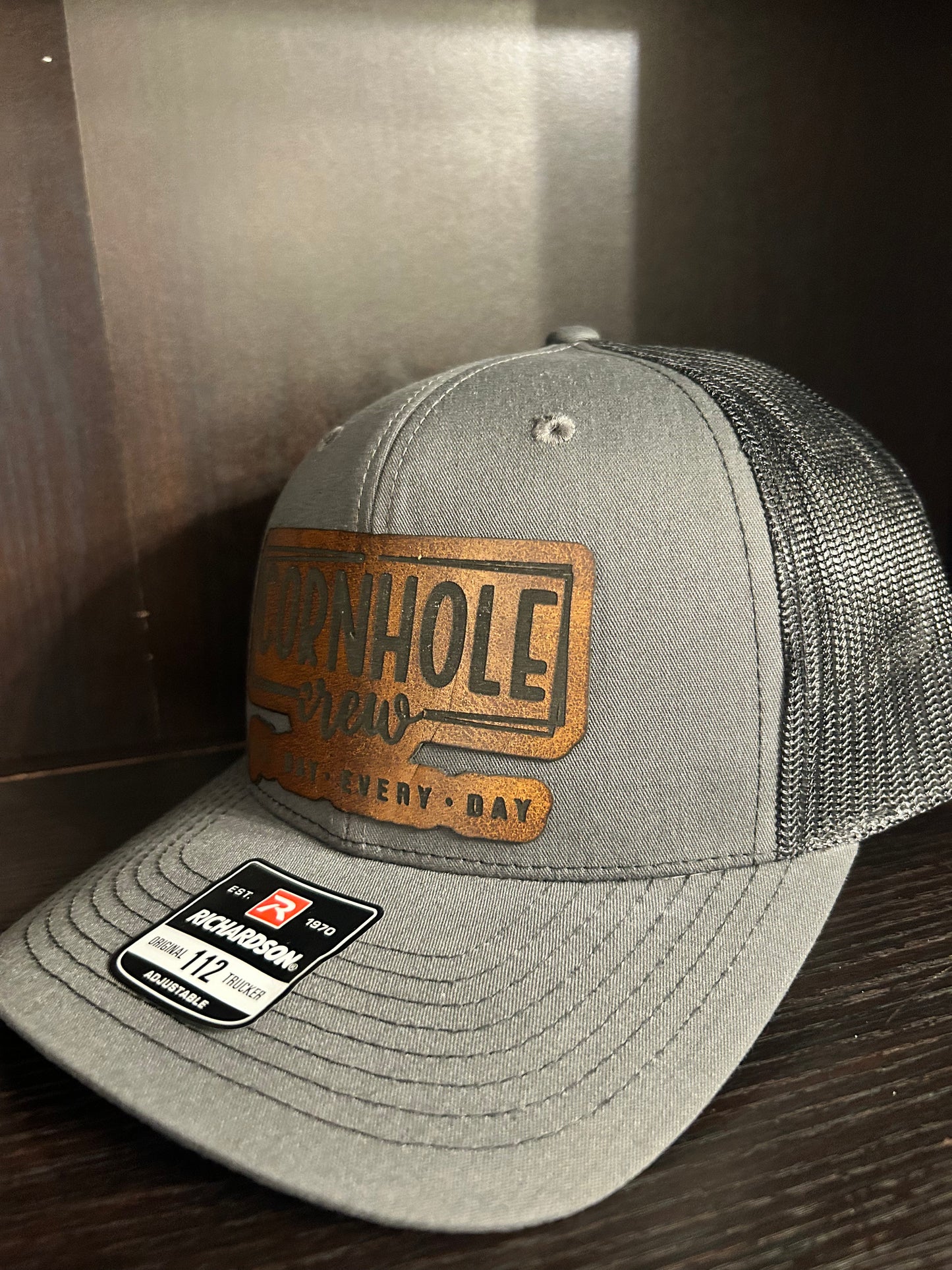 “Cornhole Crew All Day Everyday" custom leather patch on Trucker Hat Charcoal/Black