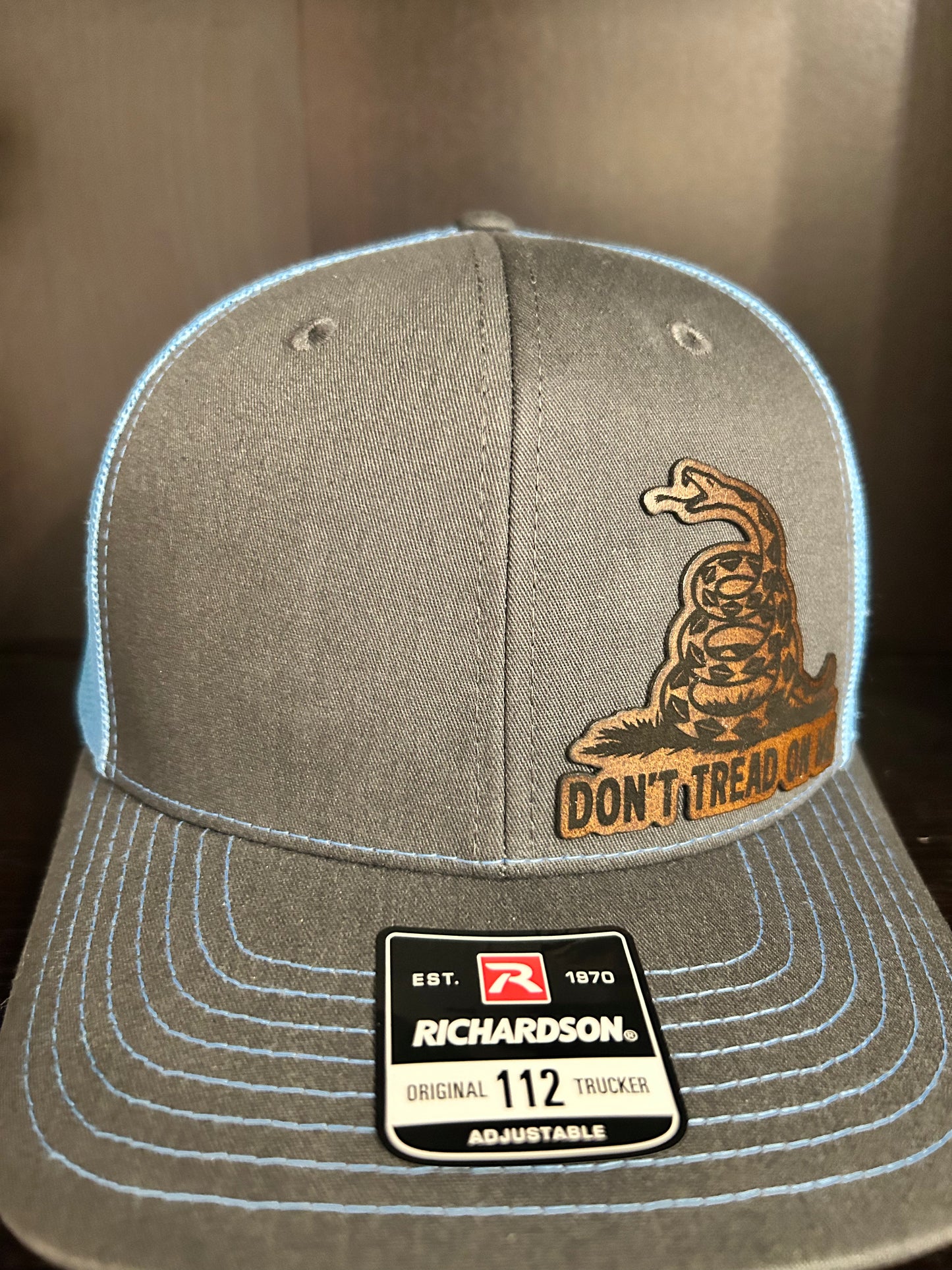“Don’t Tread On Me" custom leather patch on Trucker Hat Charcoal/Columbia Blue