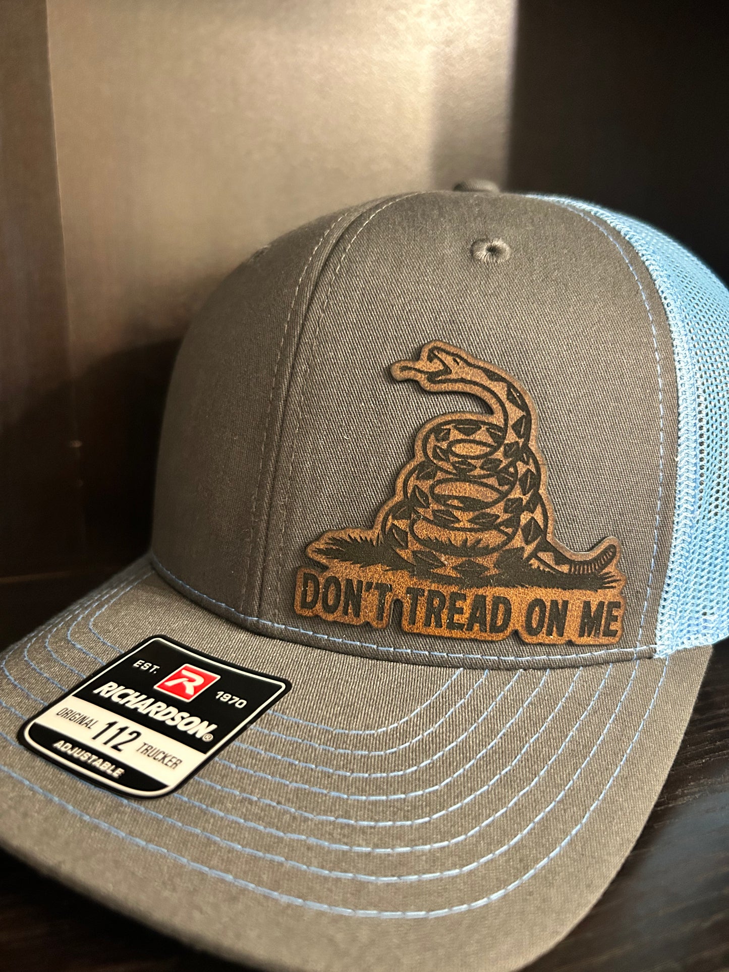“Don’t Tread On Me" custom leather patch on Trucker Hat Charcoal/Columbia Blue