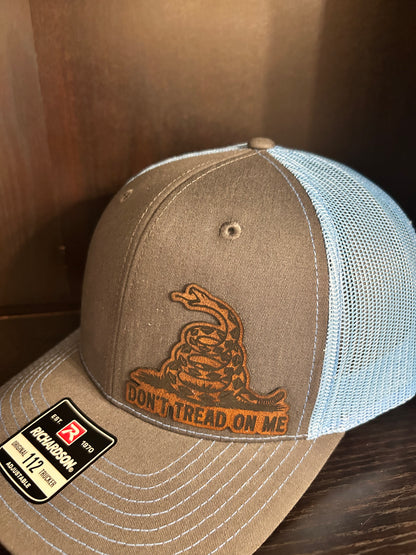 “Don’t Tread On Me" custom leather patch on Trucker Hat Charcoal/Columbia Blue