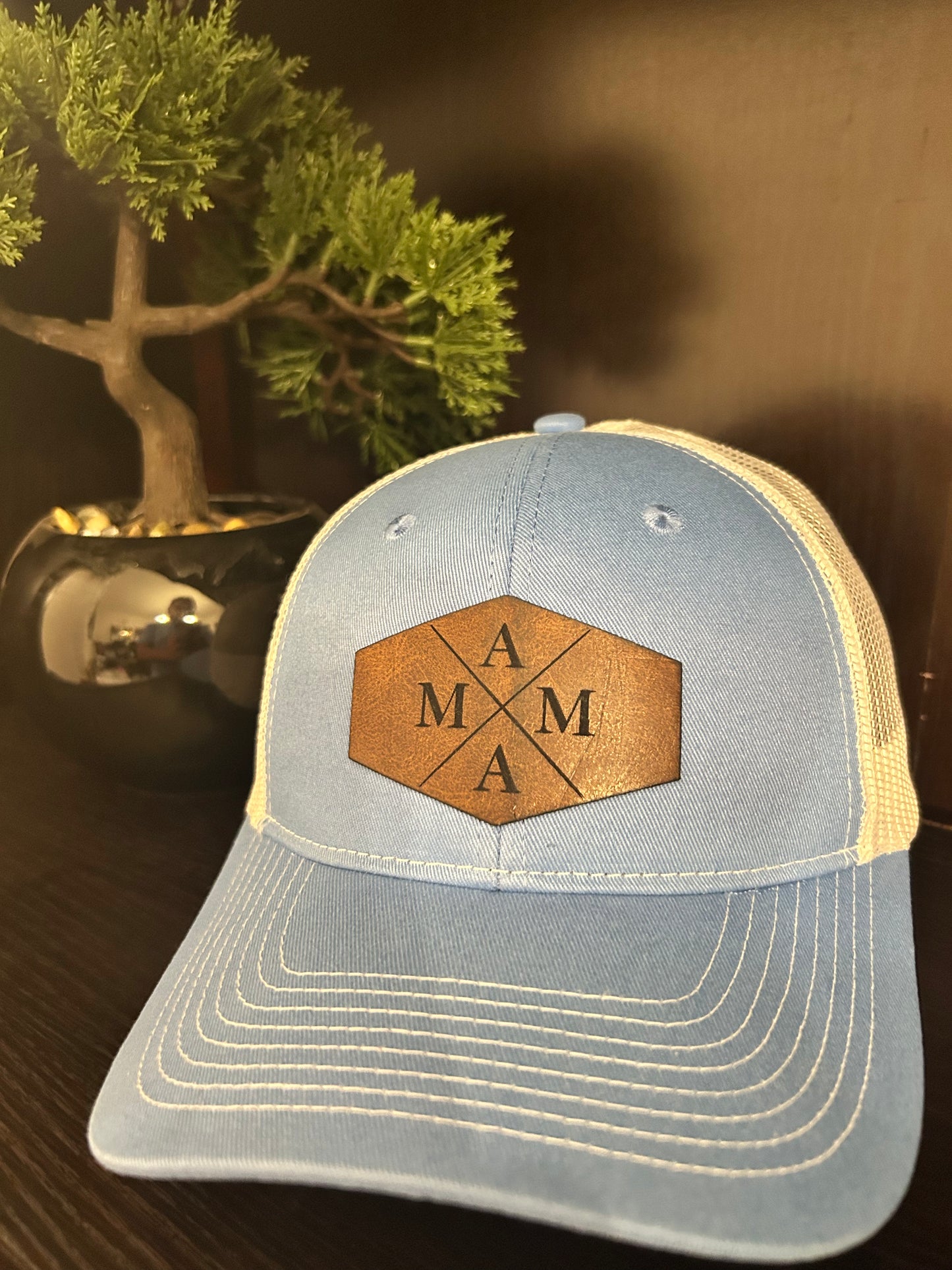 “Mama" on custom leather patch on a Trucker Hat with Pony Tail hole in the back Columbia Blue/White