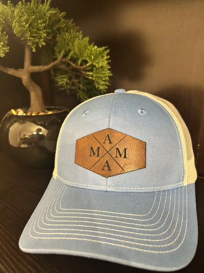 “Mama" on custom leather patch on a Trucker Hat with Pony Tail hole in the back Columbia Blue/White